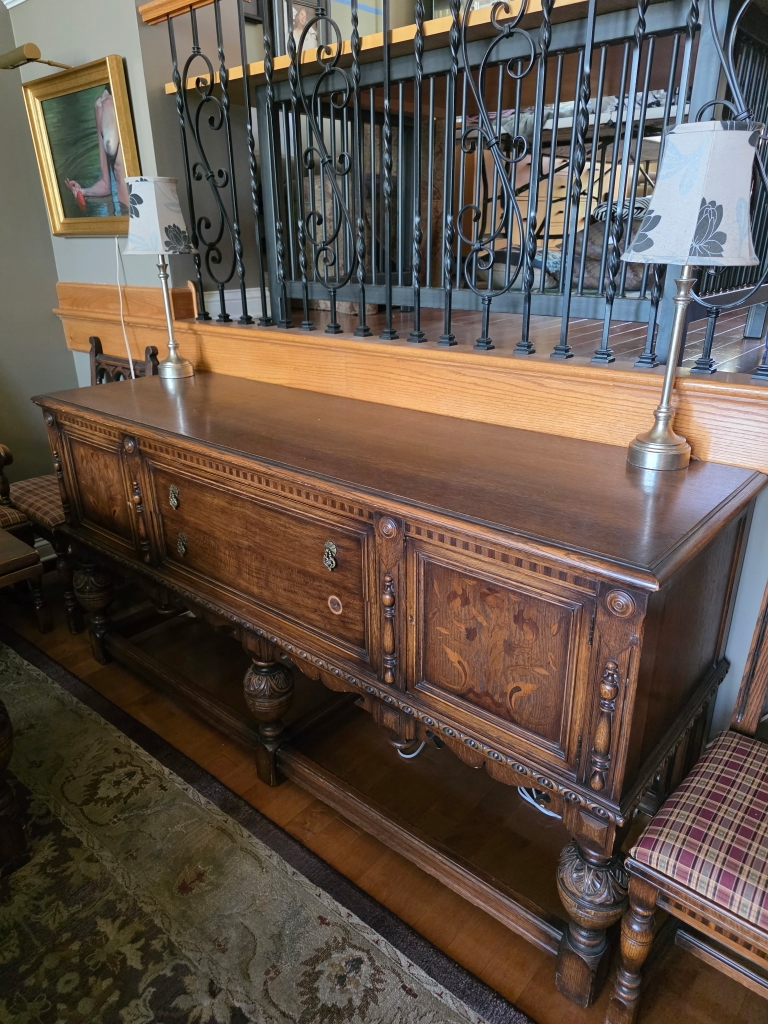 Antique carved wooden sideboard at a Compass Rose estate sale