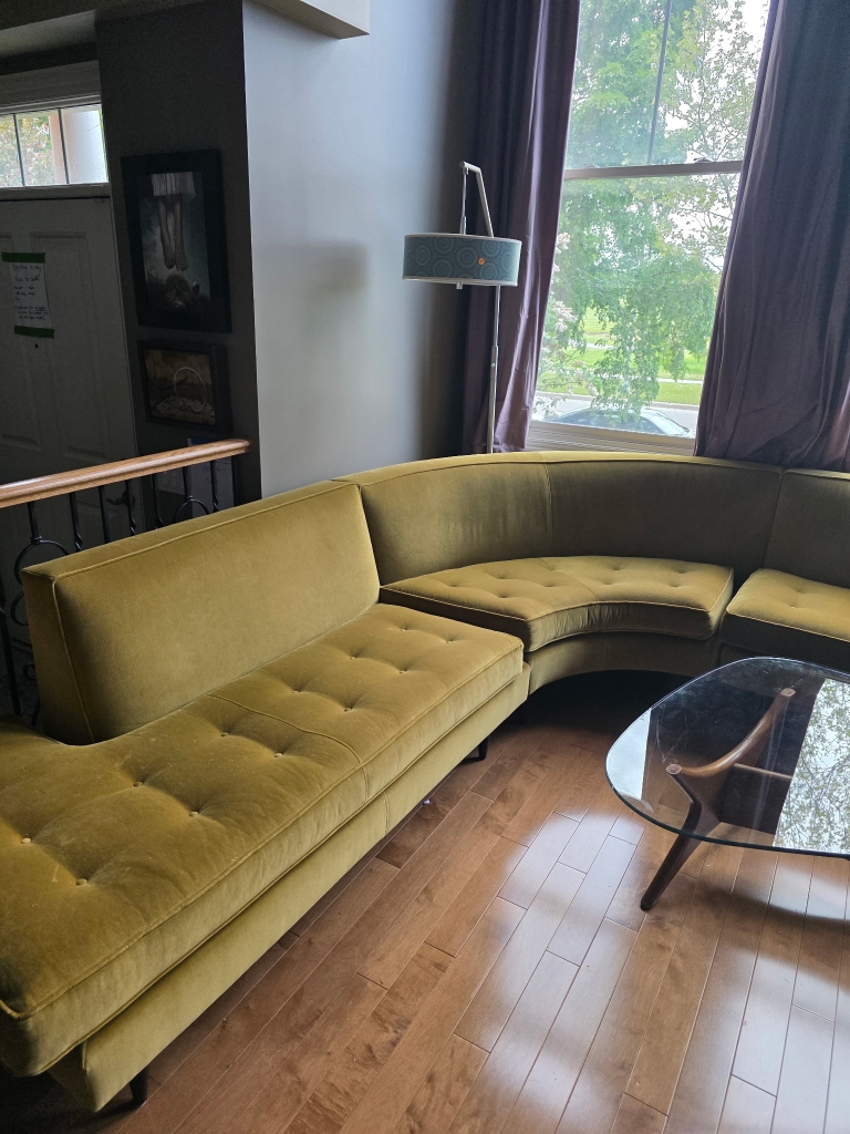 Green sectional sofa among the furnishings of an estate