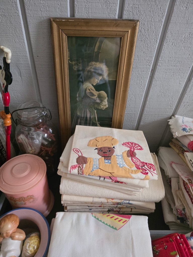 Vintage embroidered linens and household belongings in an estate