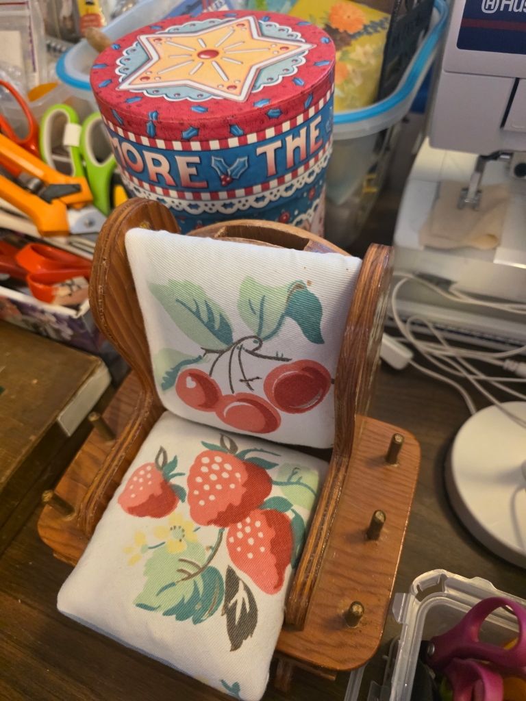 Vintage fruit-patterned linens and household collectibles prepared for sale