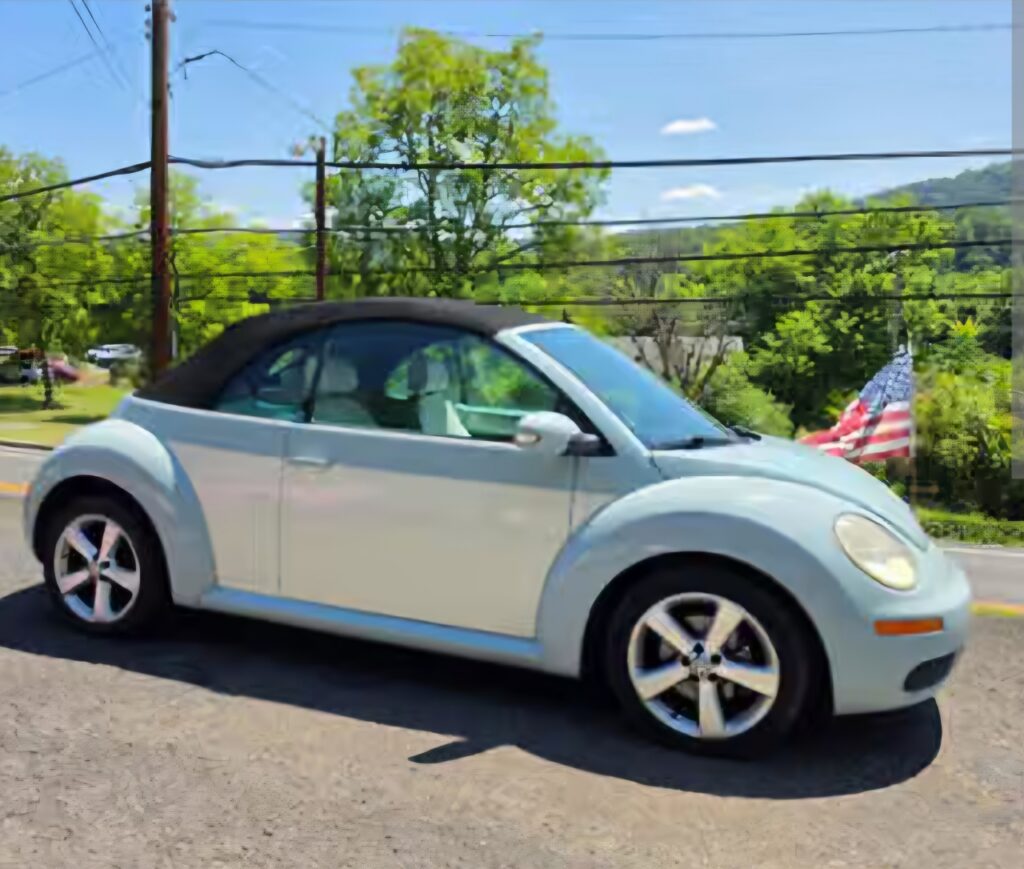 White Volkswagen Beetle convertible offered at an estate sale